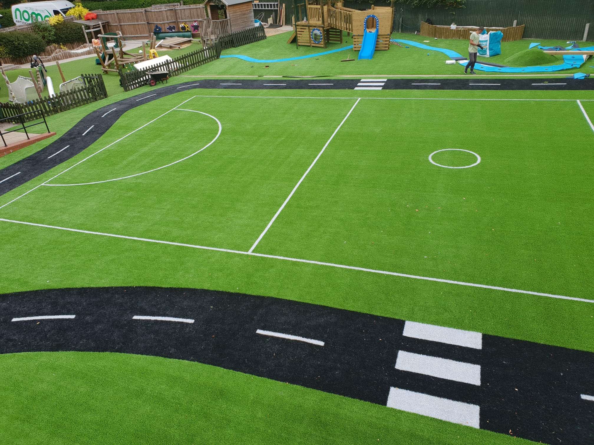 Artificial sports surface marked as a football pitch and road play area